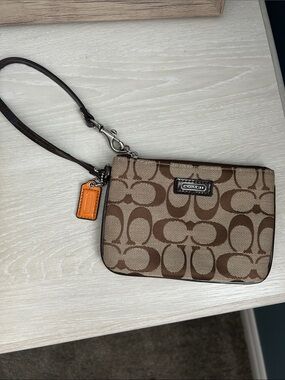 Coach Brown Signature Canvas Wristlet with Orange Charm